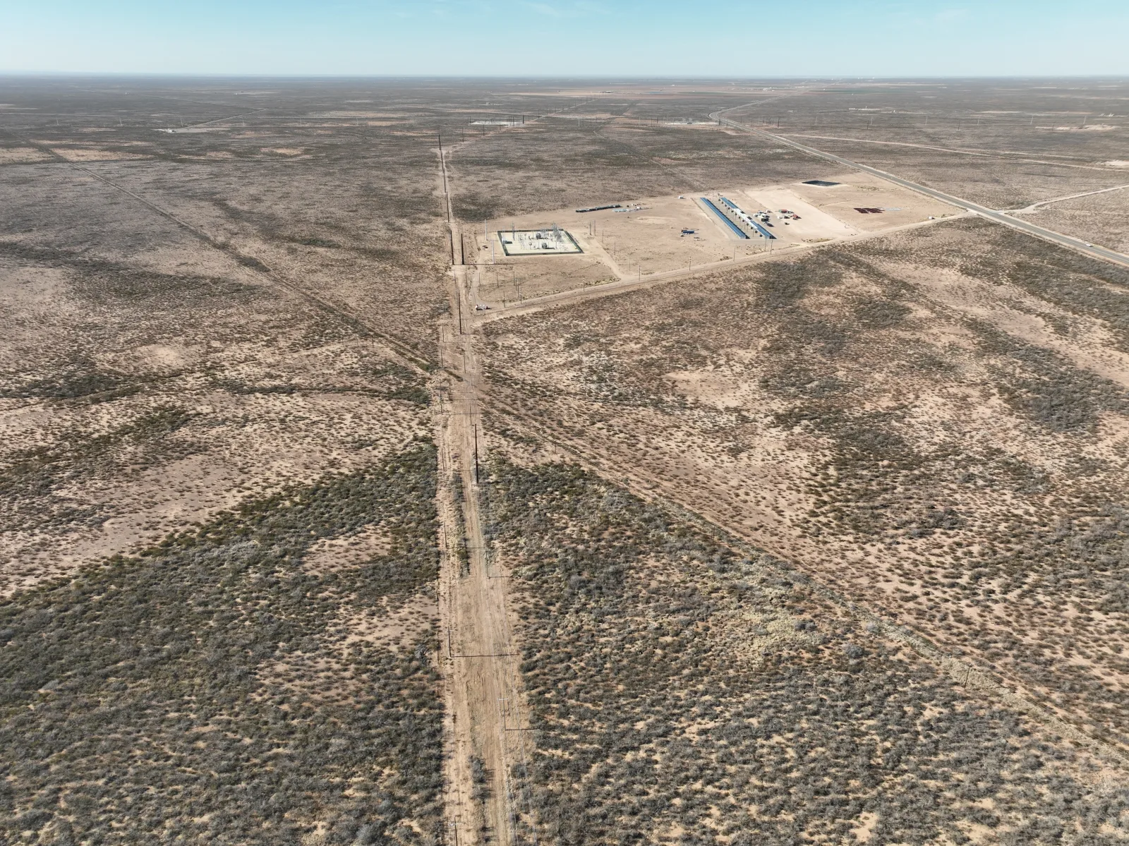 Aerial view of West Texas land, utility access road, and digital infrastructure site.